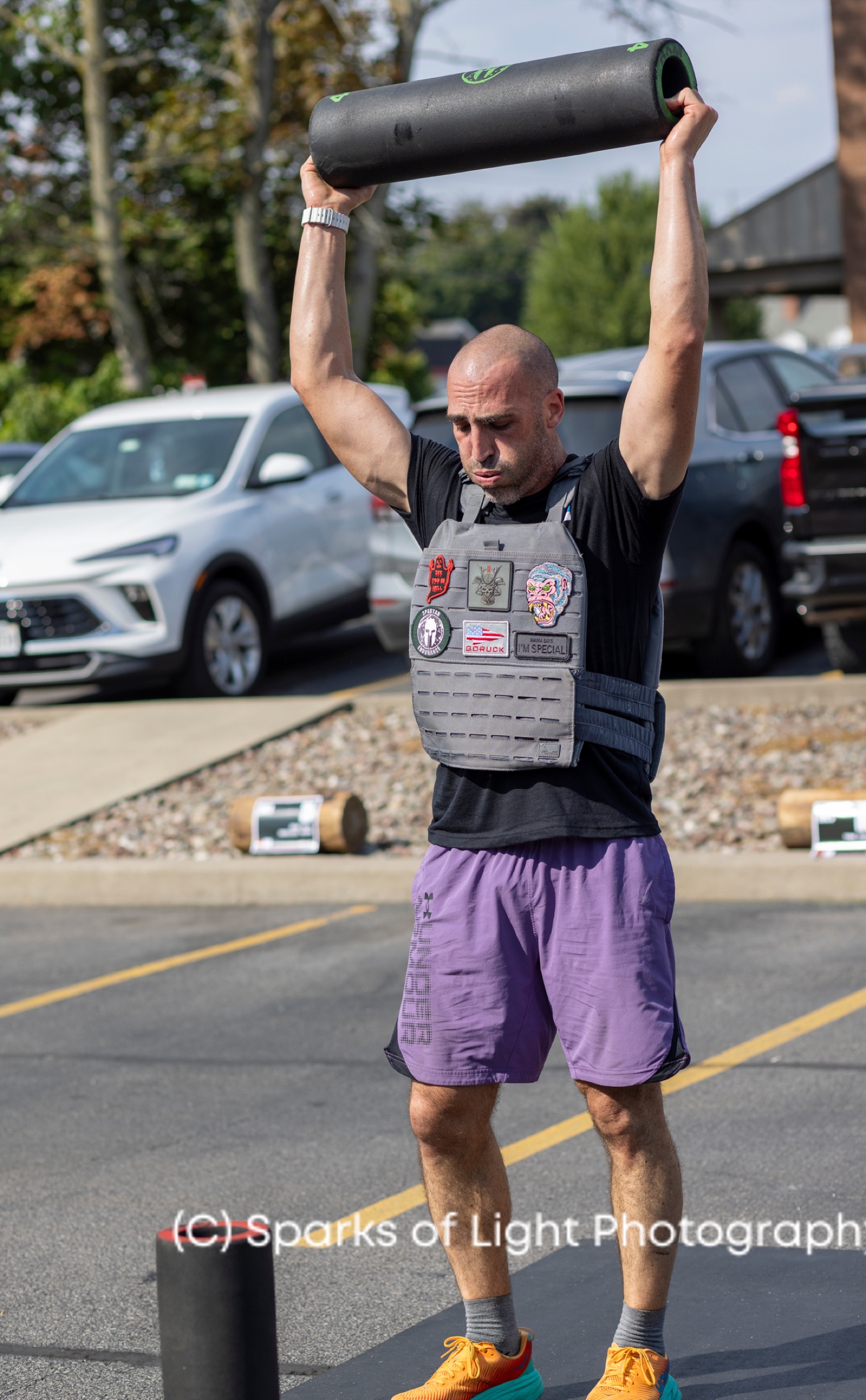 An athlete pressing a dead ball overhead at last year's DEKA event at Ruckhouse Athletics