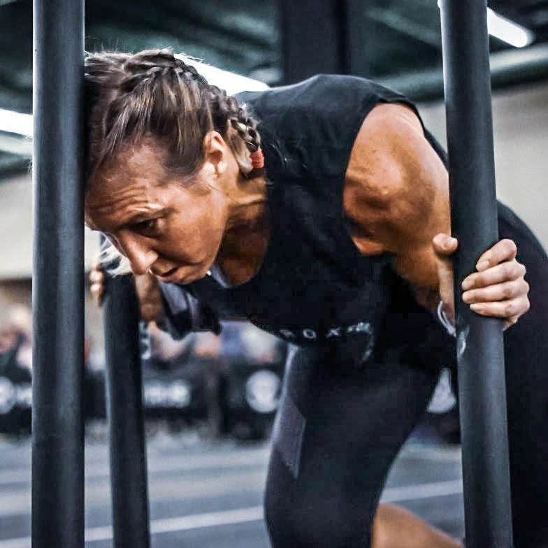 A Ruckhouse Athletics member driving the sled push at a HYROX race