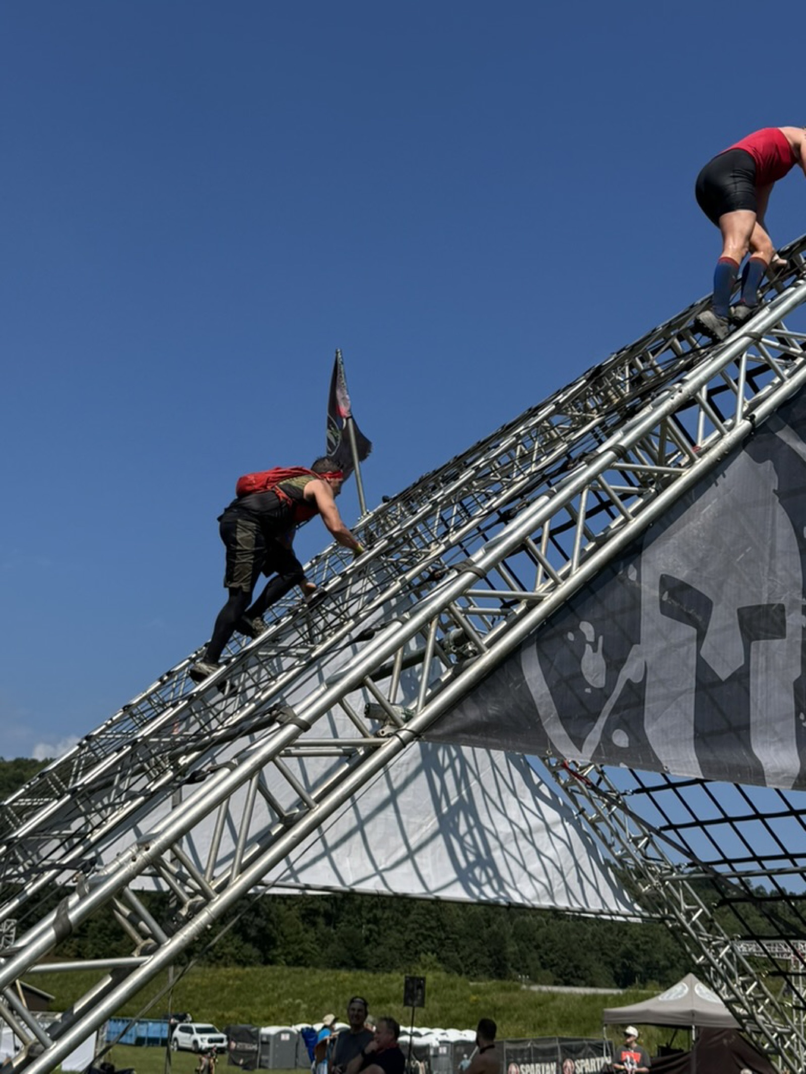 Ruckhouse athletes climbing the A-frame cargo net obstacle at the Spartan race