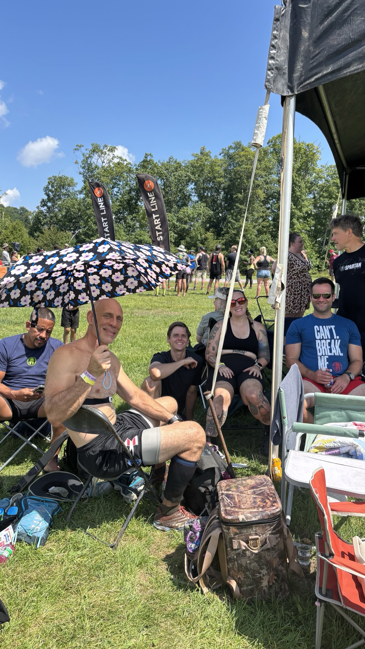 The Ruckhouse crew relaxing together at their basecamp tent between Spartan races