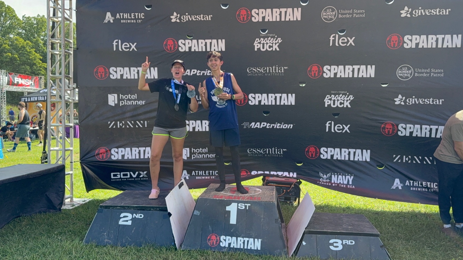 Two Ruckhouse Athletics athletes celebrating on the podium at the Spartan West Virginia Trifecta Weekend 2026